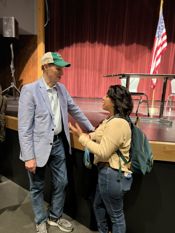 Ron Wyden talking to a woman